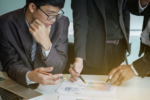 Young businessmen looking over some charts