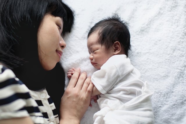 Young East Asian mother with newborn baby