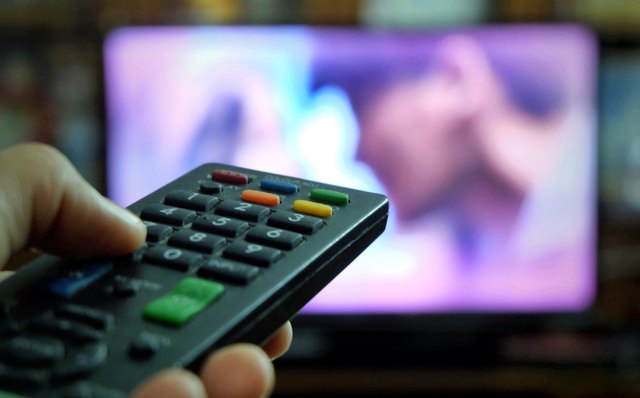 TV remote pointed toward blurry screen