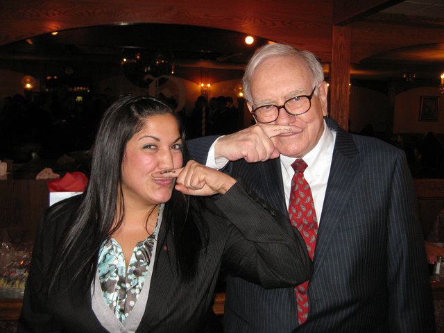 Warren Buffett poses with young business student; both have drawn mustaches on their inner fingers