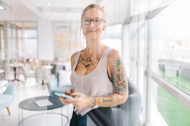 Tattooed woman in modern office setting