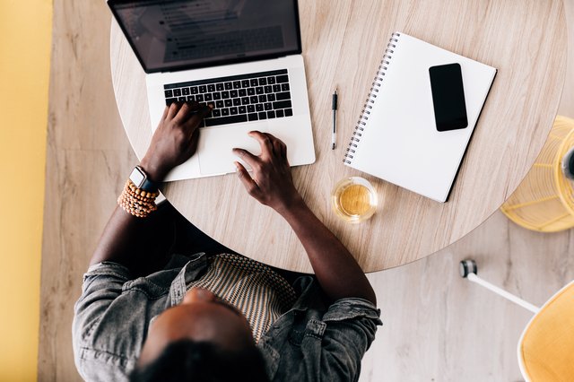 Overhead view of Black man working at laptop