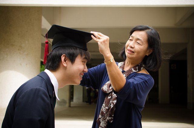 Mom adjusts grown son's graduation cap