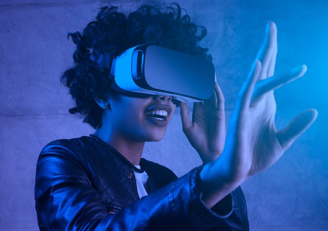 young woman touching experiencing VR helmet.