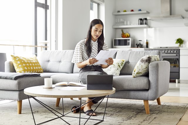 Woman with digital tablet analyzing documents