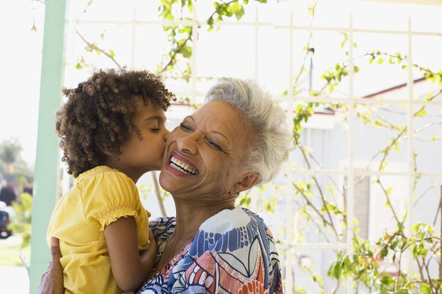 Woman and young girl embracing outdoors