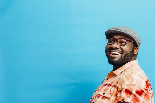 Portrait of a happy man in orange shirt looking up