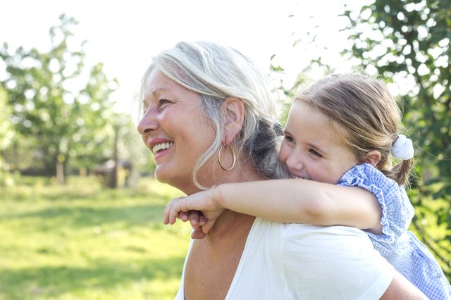 Little girl on a piggy back ride with her grandmother