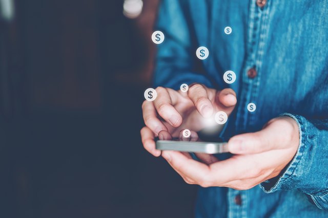 Digital Composite Image Of Man Using Mobile Phone With Bitcoin Symbol