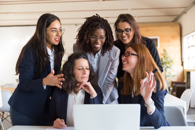 Front view of cheerful businesswomen talking during work