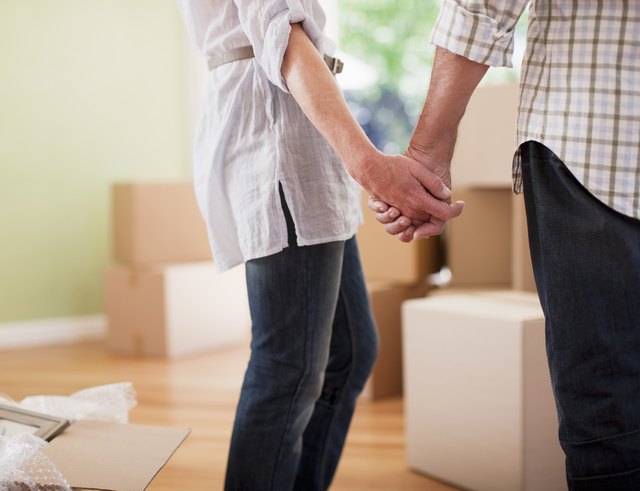 Couple holding hands in new house