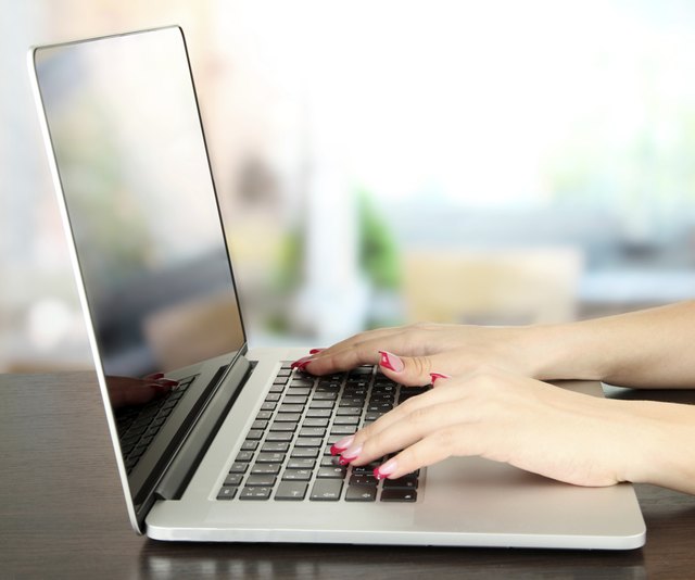 Female hands typing on laptop