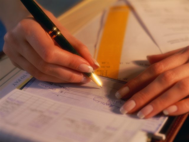 Hands writing check