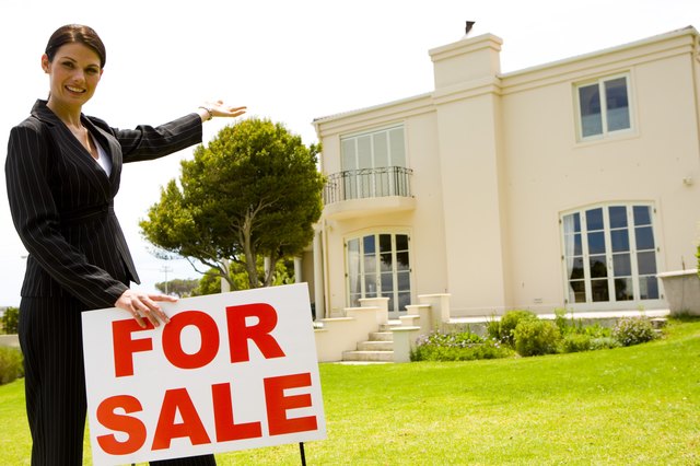 Real estate agent with house for sale