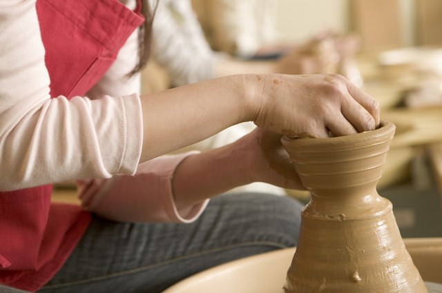 Hands of woman turning pottery wheel