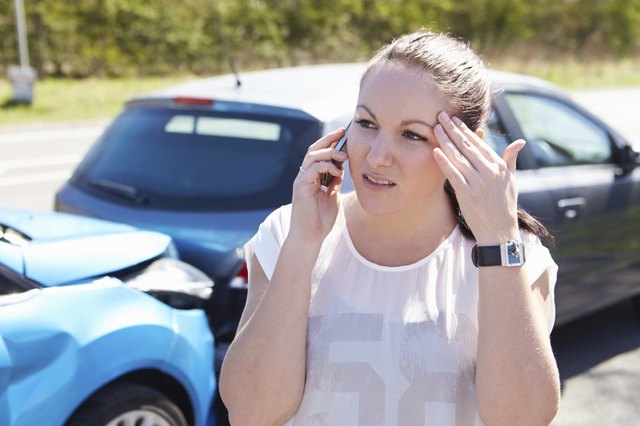 Female Driver Making Phone Call After Traffic Accident
