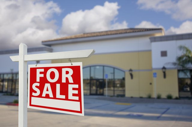 Vacant Retail Building with For Sale Real Estate Sign