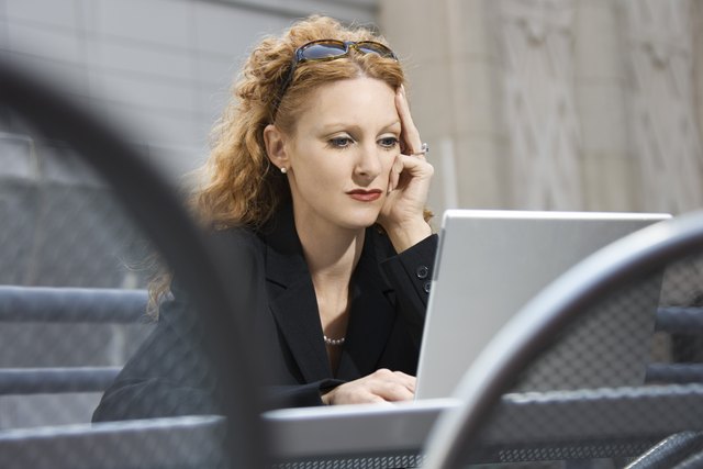 Businesswoman using laptop outdoors