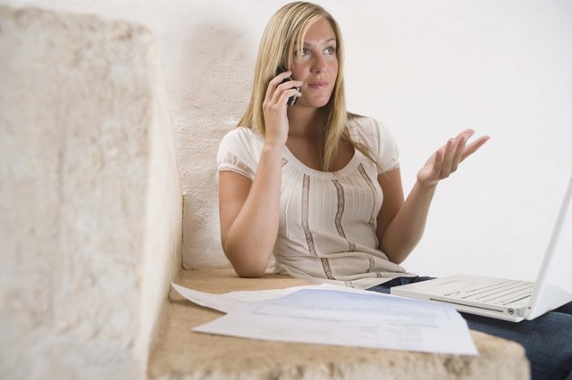 Woman with bills and cell phone