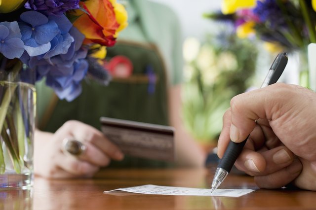 Man Signing Receipt for Flowers