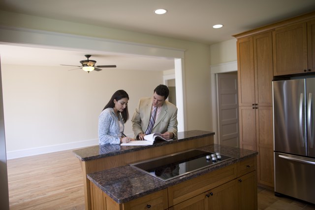 Woman and realtor signing contract to new home