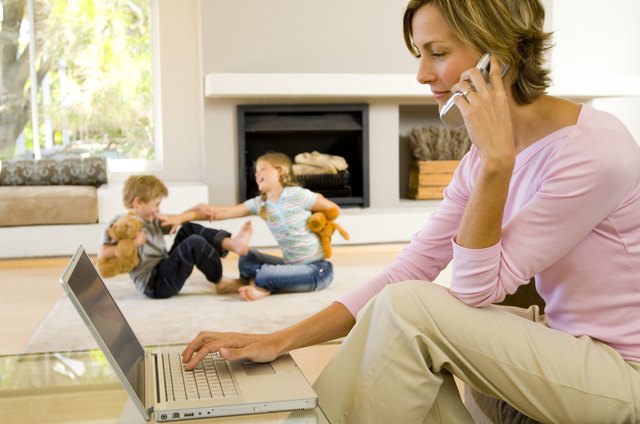 Woman talking on phone and using laptop computer