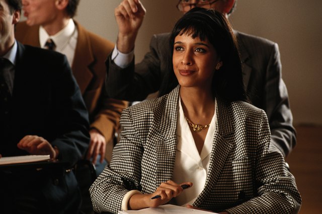 People in conference room, focus on women in foreground