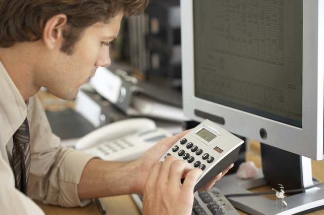 Businessman using calculator