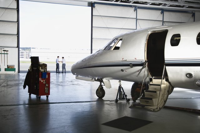 Airplane in hangar with men in background