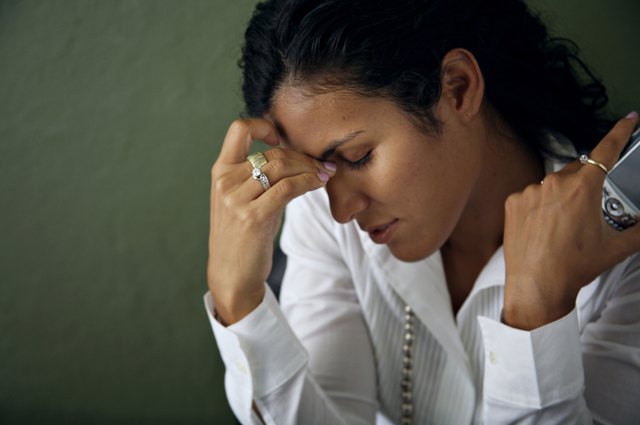 Businesswoman holding a mobile phone and looking upset