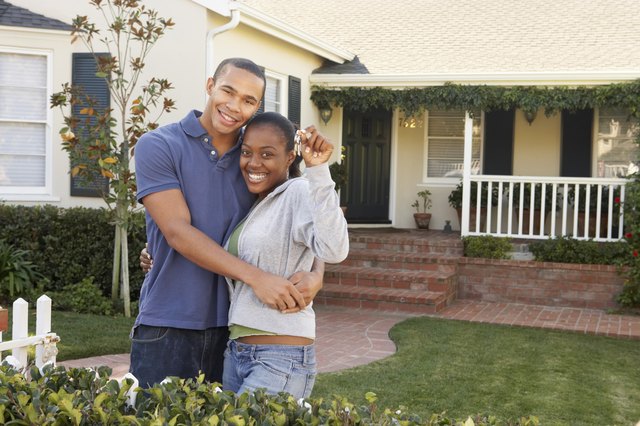 Couple standing in front of a house