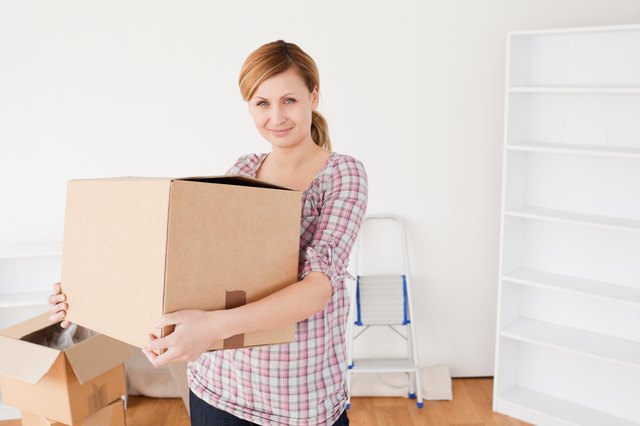 Attractive woman carrying cardboard boxes