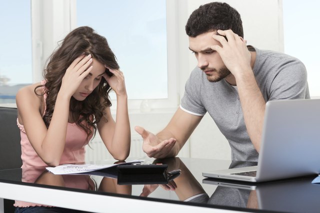man upset after looking at card statement.