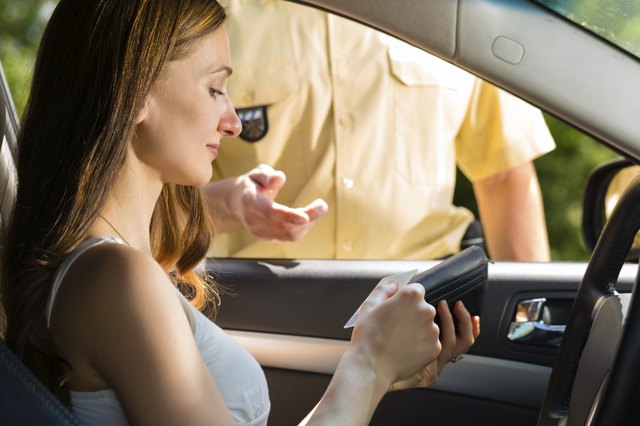 Police - woman in traffic violation getting ticket