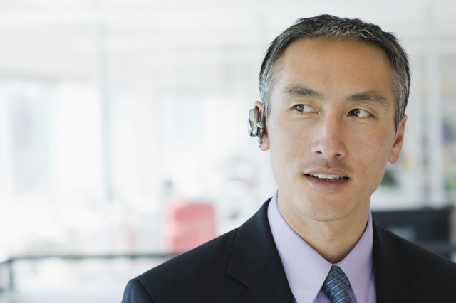 Businessman wearing cell phone earpiece