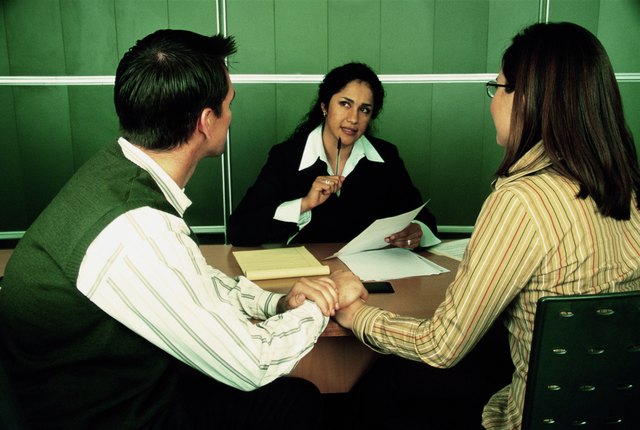 Businesswoman talking to couple