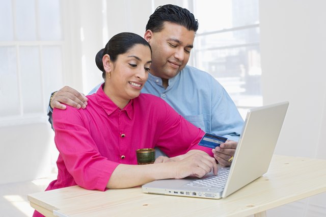 Woman and man with laptop and credit card