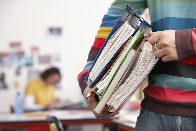 Young Man Carrying File Folders