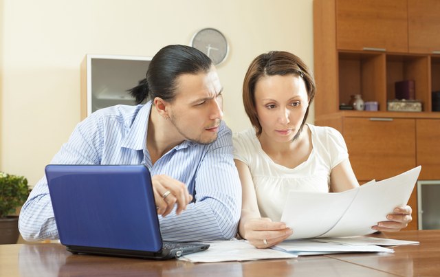serious couple reading document