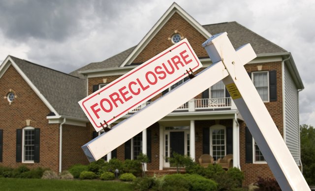 Foreclosure sign in front on modern house