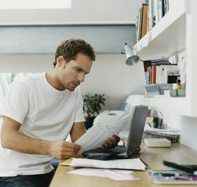 Serious Man Examining a Bill