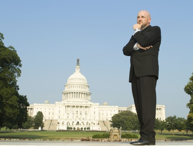 "Thoughtful Caucasian Man, Suit, Standing U.S. Capitol Building,"
