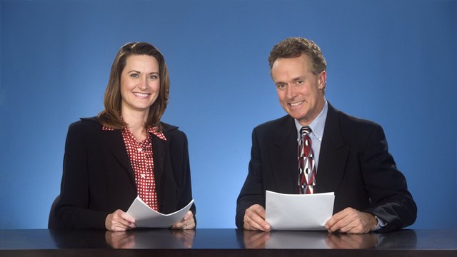 Smilng newcasters.