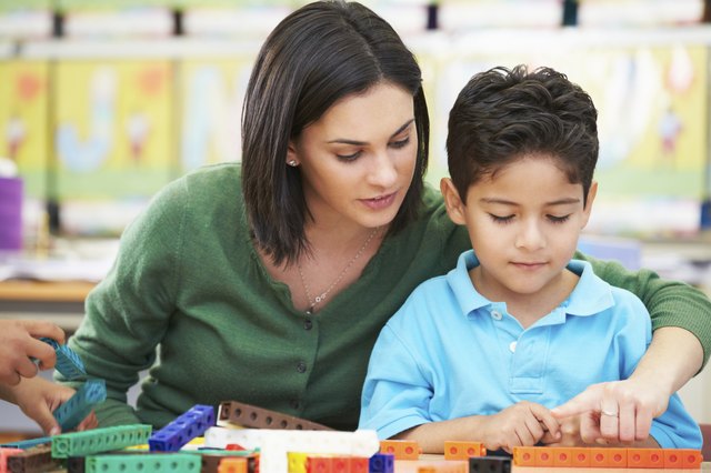 Elementary Pupil Counting With Teacher In Classroom