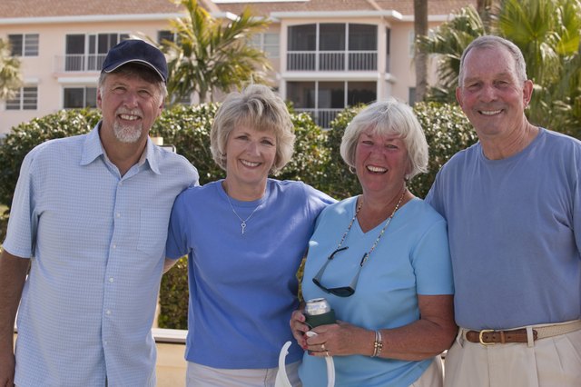 Four senior friends standing together and smiling