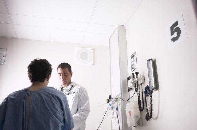 Doctor examining patient in hospital