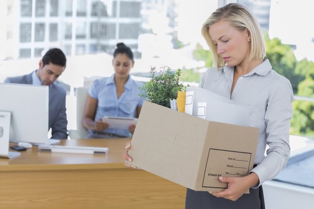 Sad businesswoman leaving office after being let go
