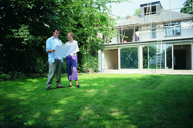 Couple Discussing Blueprints to New Home