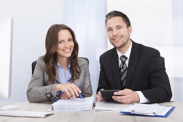 Businesspeople Calculating Finance