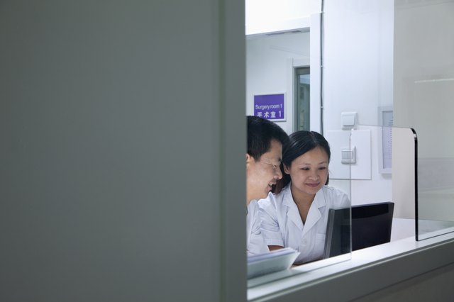 Veterinarians looking at computer screen